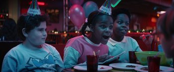 A group of people sitting at a table with balloons