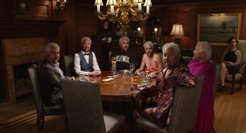 Movie still from “80 for Brady” (2023), directed by Kyle Marvin – A group of people sitting around a table; Wide shot, High angle