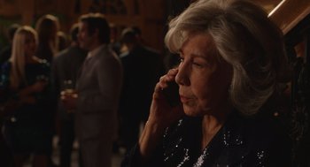 Movie still from “80 for Brady” (2023), directed by Kyle Marvin – An older woman talking on a cell phone in front of a crowd; Close Up shot, Over the shoulder angle