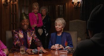 Movie still from “80 for Brady” (2023), directed by Kyle Marvin – A group of people sitting at a table playing cards; Medium shot, Over the shoulder angle