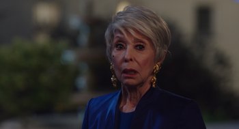 Movie still from “80 for Brady” (2023), directed by Kyle Marvin – An older woman with short hair wearing a blue jacket; Close Up shot, Over the shoulder angle