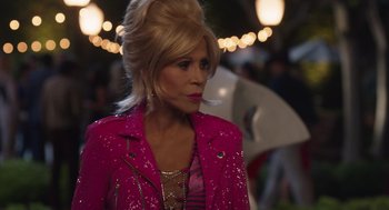 Movie still from “80 for Brady” (2023), directed by Kyle Marvin – A woman in a pink jacket and a pink dress; Close Up shot, Over the shoulder angle