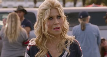 Movie still from “80 for Brady” (2023), directed by Kyle Marvin – A woman with blonde hair and a red lipstick; Close Up shot, Over the shoulder angle