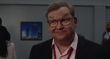 Movie still from “80 for Brady” (2023), directed by Kyle Marvin – An older man wearing glasses and a suit; Close Up shot, Over the shoulder angle