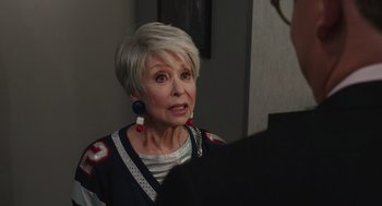 Movie still from “80 for Brady” (2023), directed by Kyle Marvin – An older woman with short blonde hair wearing earrings; Close Up shot, Over the shoulder angle