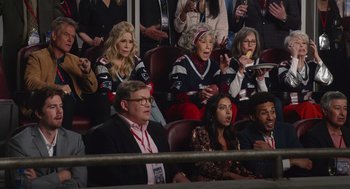 Movie still from “80 for Brady” (2023), directed by Kyle Marvin – A group of people sitting in chairs in an arena; Wide shot, High angle