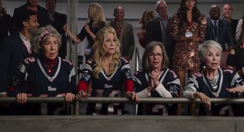 Movie still from “80 for Brady” (2023), directed by Kyle Marvin – A group of women sitting next to each other in a stadium; Medium shot, High angle