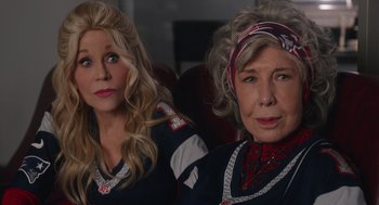 Movie still from “80 for Brady” (2023), directed by Kyle Marvin – Two women sitting next to each other on a couch; Close Up shot, High angle