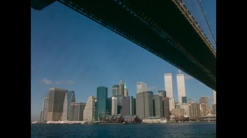 Movie still from “9/11: Inside the President's War Room” (2021), directed by Adam Wishart – A view of a city from under a bridge; Extreme Wide shot, Low angle