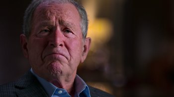 Movie still from “9/11: Inside the President's War Room” (2021), directed by Adam Wishart – An older man with a frowning look on his face; Close Up shot, Low angle