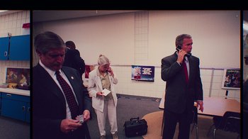 Movie still from “9/11: Inside the President's War Room” (2021), directed by Adam Wishart – A group of people standing in a room; Medium shot, High angle