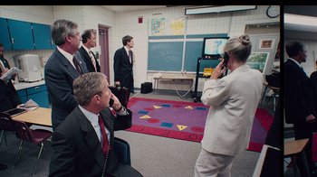 Movie still from “9/11: Inside the President's War Room” (2021), directed by Adam Wishart – A group of men and a woman in a room; Wide shot, High angle