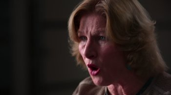 Movie still from “9/11: Inside the President's War Room” (2021), directed by Adam Wishart – An older woman with short blonde hair looking surprised; Close Up shot, Low angle