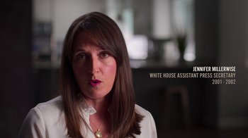 Movie still from “9/11: Inside the President's War Room” (2021), directed by Adam Wishart – A person wearing a white shirt; Close Up shot, Over the shoulder angle