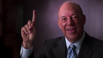Movie still from “9/11: Inside the President's War Room” (2021), directed by Adam Wishart – A man in a suit and tie holding up a finger; Close Up shot, Low angle
