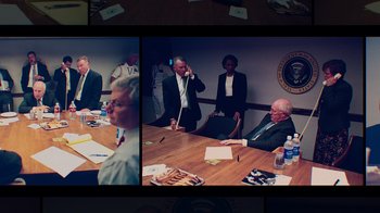 Movie still from “9/11: Inside the President's War Room” (2021), directed by Adam Wishart – A group of people sitting around a table; Medium shot, High angle