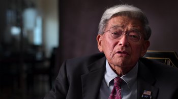 Movie still from “9/11: Inside the President's War Room” (2021), directed by Adam Wishart – An older man wearing a suit and tie; Close Up shot, Low angle