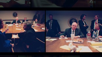Movie still from “9/11: Inside the President's War Room” (2021), directed by Adam Wishart – A group of people sitting around a table; Medium shot, High angle