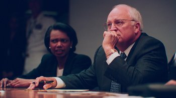 Movie still from “9/11: Inside the President's War Room” (2021), directed by Adam Wishart – A man and a woman sitting in front of a computer; Medium shot, Over the shoulder angle