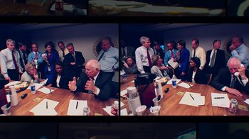 Movie still from “9/11: Inside the President's War Room” (2021), directed by Adam Wishart – A group of people sitting around a table; Medium shot, High angle