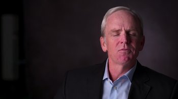 Movie still from “9/11: Inside the President's War Room” (2021), directed by Adam Wishart – An older man in a black jacket and a blue dress shirt; Close Up shot, Low angle