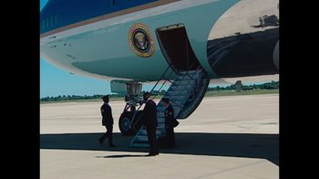 Movie still from “9/11: Inside the President's War Room” (2021), directed by Adam Wishart – Three men are walking up the stairs of an air force one; Wide shot, Low angle