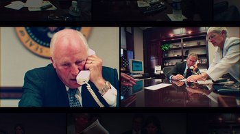 Movie still from “9/11: Inside the President's War Room” (2021), directed by Adam Wishart – A man talking on a phone in an office setting; Medium shot, High angle