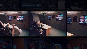 Movie still from “9/11: Inside the President's War Room” (2021), directed by Adam Wishart – A series of pictures of a room with a man sitting at a desk; Wide shot, High angle
