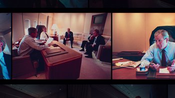 Movie still from “9/11: Inside the President's War Room” (2021), directed by Adam Wishart – A group of people sitting in a living room; Wide shot, High angle