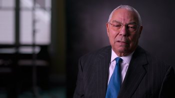 Movie still from “9/11: Inside the President's War Room” (2021), directed by Adam Wishart – An older man wearing a suit and tie; Close Up shot, Low angle
