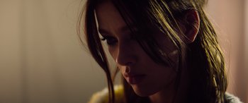 Movie still from “A Banquet” (2021), directed by Ruth Paxton – A person with long hair; Close Up shot, Low angle