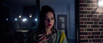 Movie still from “A Banquet” (2021), directed by Ruth Paxton – A woman holding a cell phone up to her face; Close Up shot, Low angle