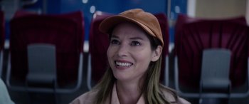Movie still from “A Banquet” (2021), directed by Ruth Paxton – A woman wearing a brown hat sitting on a bus; Close Up shot, Over the shoulder angle