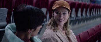 Movie still from “A Banquet” (2021), directed by Ruth Paxton – A woman wearing a hat talking to another woman; Close Up shot, Over the shoulder angle