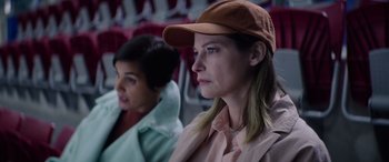 Movie still from “A Banquet” (2021), directed by Ruth Paxton – Two women are sitting in a row of seats; Close Up shot, Over the shoulder angle