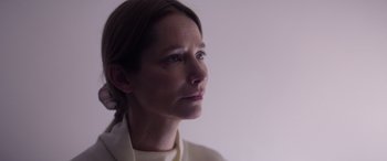 Movie still from “A Banquet” (2021), directed by Ruth Paxton – A person looking to her left; Close Up shot, Low angle