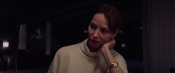 Movie still from “A Banquet” (2021), directed by Ruth Paxton – A woman in a white shirt and a gold watch; Close Up shot, Over the shoulder angle