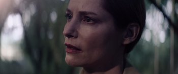 Movie still from “A Banquet” (2021), directed by Ruth Paxton – A woman's face with a blurry background; Close Up shot, Over the shoulder angle