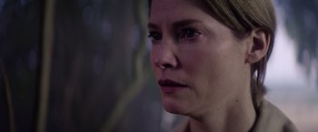 Movie still from “A Banquet” (2021), directed by Ruth Paxton – A woman's face in the dark; Close Up shot, Over the shoulder angle