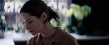Movie still from “A Banquet” (2021), directed by Ruth Paxton – A person wearing a brown shirt; Close Up shot, Low angle