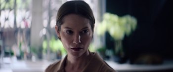Movie still from “A Banquet” (2021), directed by Ruth Paxton – A person wearing a brown shirt; Close Up shot, Low angle