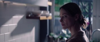 Movie still from “A Banquet” (2021), directed by Ruth Paxton – A person looking at the camera; Close Up shot, Low angle