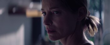 Movie still from “A Banquet” (2021), directed by Ruth Paxton – A woman's face in the dark; Close Up shot, Low angle