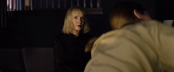 Movie still from “A Banquet” (2021), directed by Ruth Paxton – An older woman sitting in front of another woman; Close Up shot, Over the shoulder angle