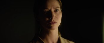 Movie still from “A Banquet” (2021), directed by Ruth Paxton – A person in a dark room; Close Up shot, Low angle