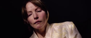 Movie still from “A Banquet” (2021), directed by Ruth Paxton – A person with her eyes closed; Close Up shot, High angle