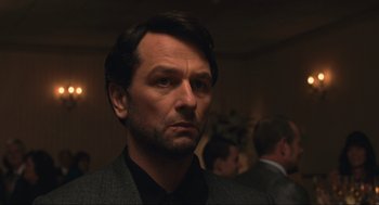 Movie still from “A Beautiful Day in the Neighborhood” (2019), directed by Marielle Heller – A person wearing a suit and tie; Close Up shot, Over the shoulder angle