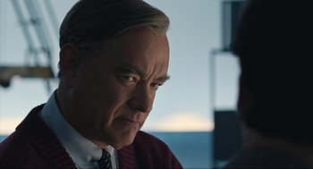 Movie still from “A Beautiful Day in the Neighborhood” (2019), directed by Marielle Heller – A man in a suit and tie looking to his left; Close Up shot, Over the shoulder angle
