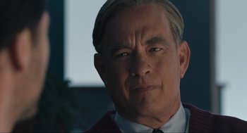 Movie still from “A Beautiful Day in the Neighborhood” (2019), directed by Marielle Heller – A person wearing a suit and tie; Close Up shot, Over the shoulder angle