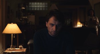 Movie still from “A Beautiful Day in the Neighborhood” (2019), directed by Marielle Heller – A person sitting in a dark room; Close Up shot, Low angle